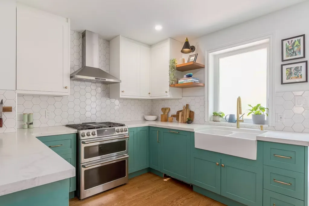 Kitchen with teal green shaker base cabinets, white hexagon tile backsplash and a farmhouse sink
