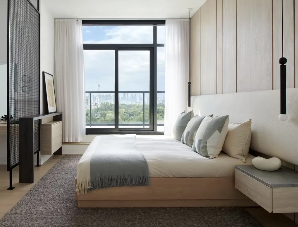 Bedroom with a floating oak bed, a floating nightstand and a vertical wood panel headboard wall