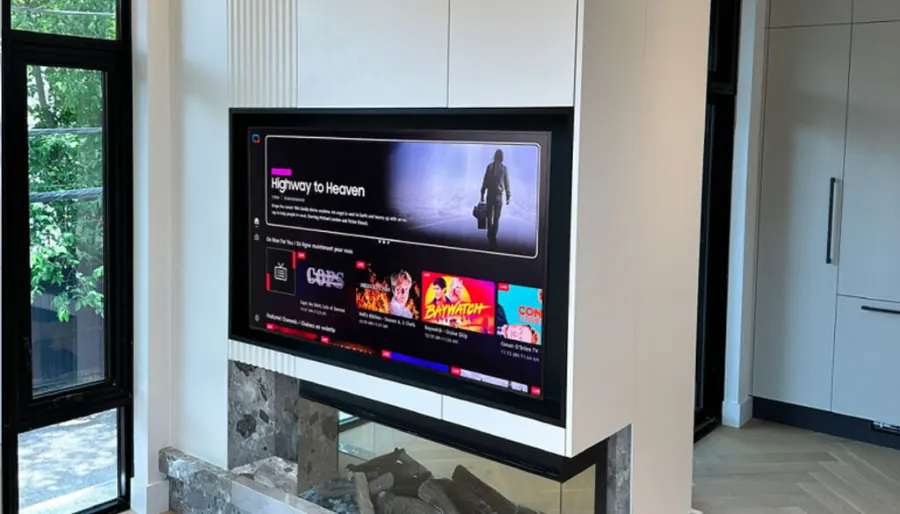 TV feature wall with built-in cabinetry around a fireplace by VIVA Cabinetry